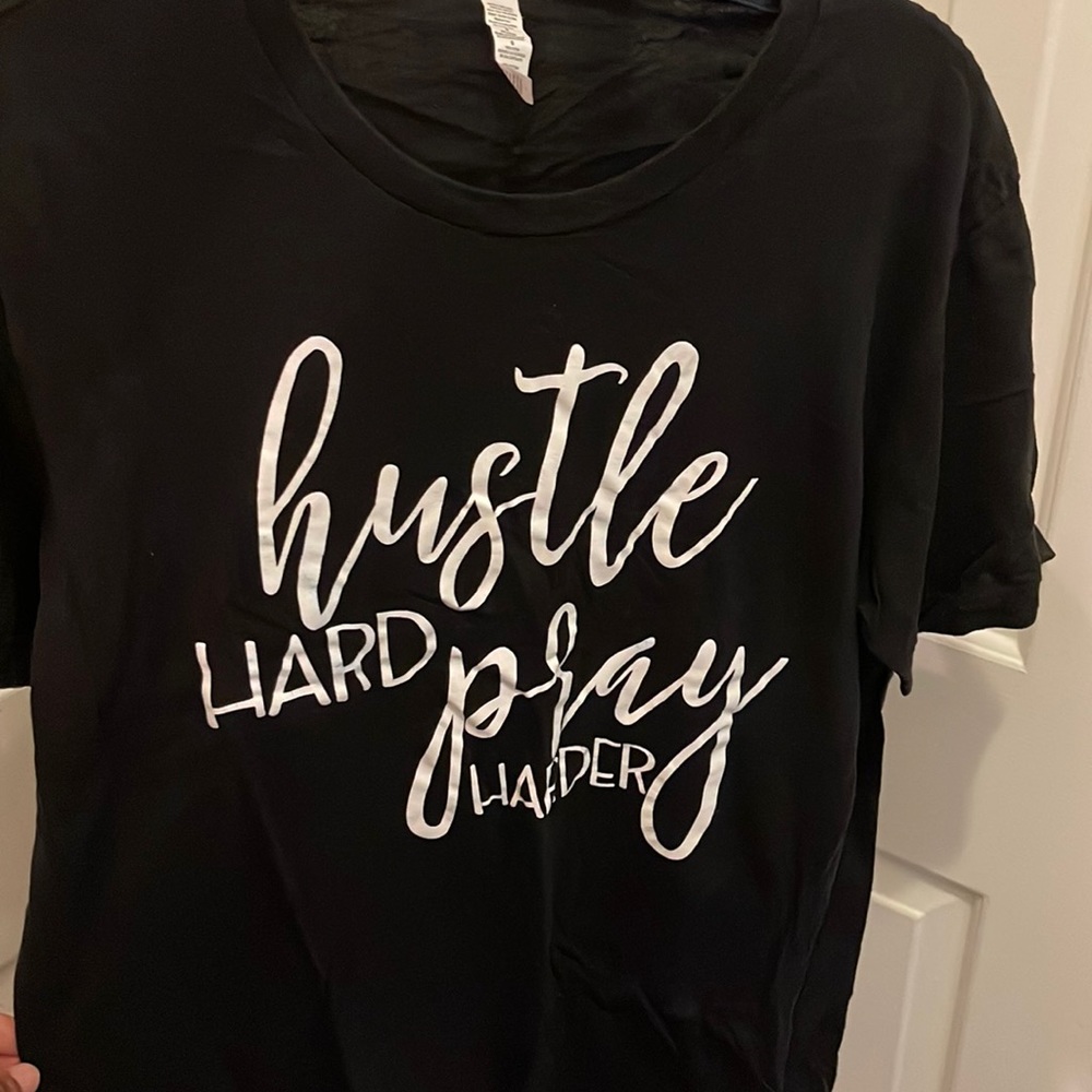 Selling a graphic tee that says HUSTLE HARD PRAY HARDER. A size Large.